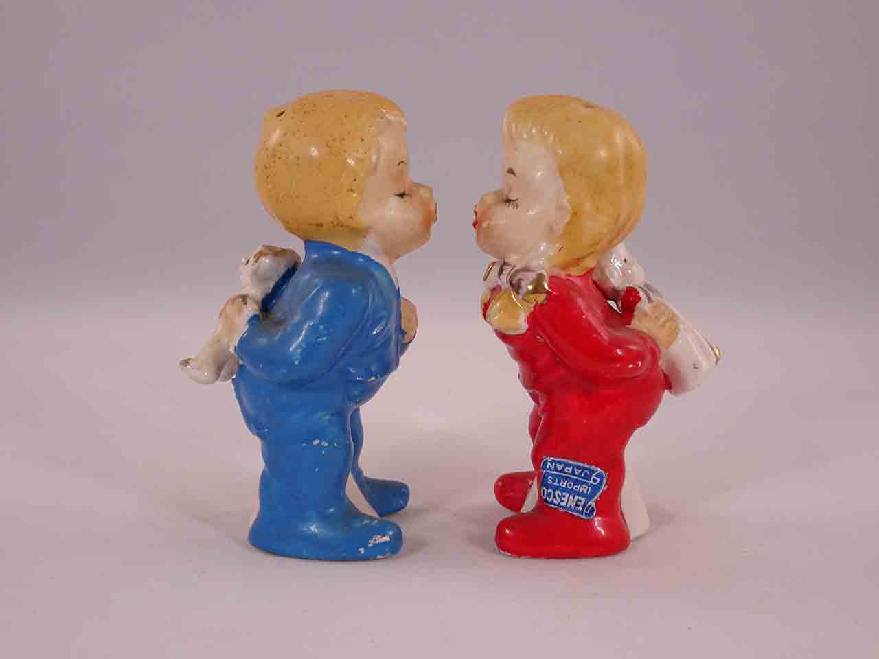 Kissing American children holding objects behind their backs salt and pepper shakers