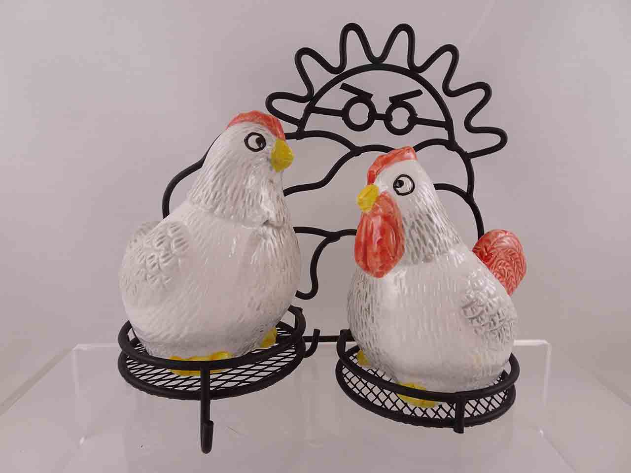 Chickens on metal stand depicting a sunrise salt and pepper shakers