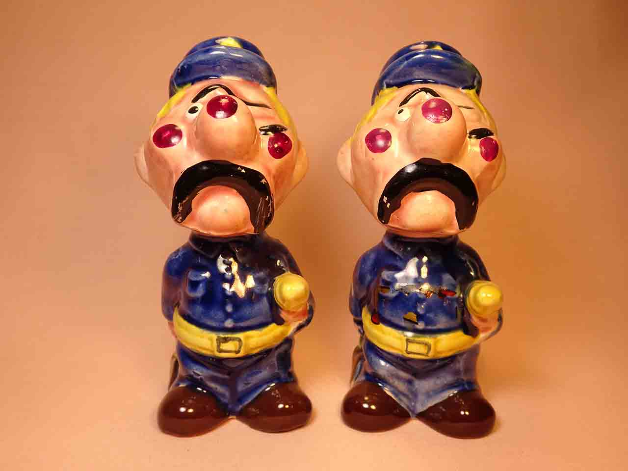 Clown-like strange fellows salt and pepper shakers - police officers