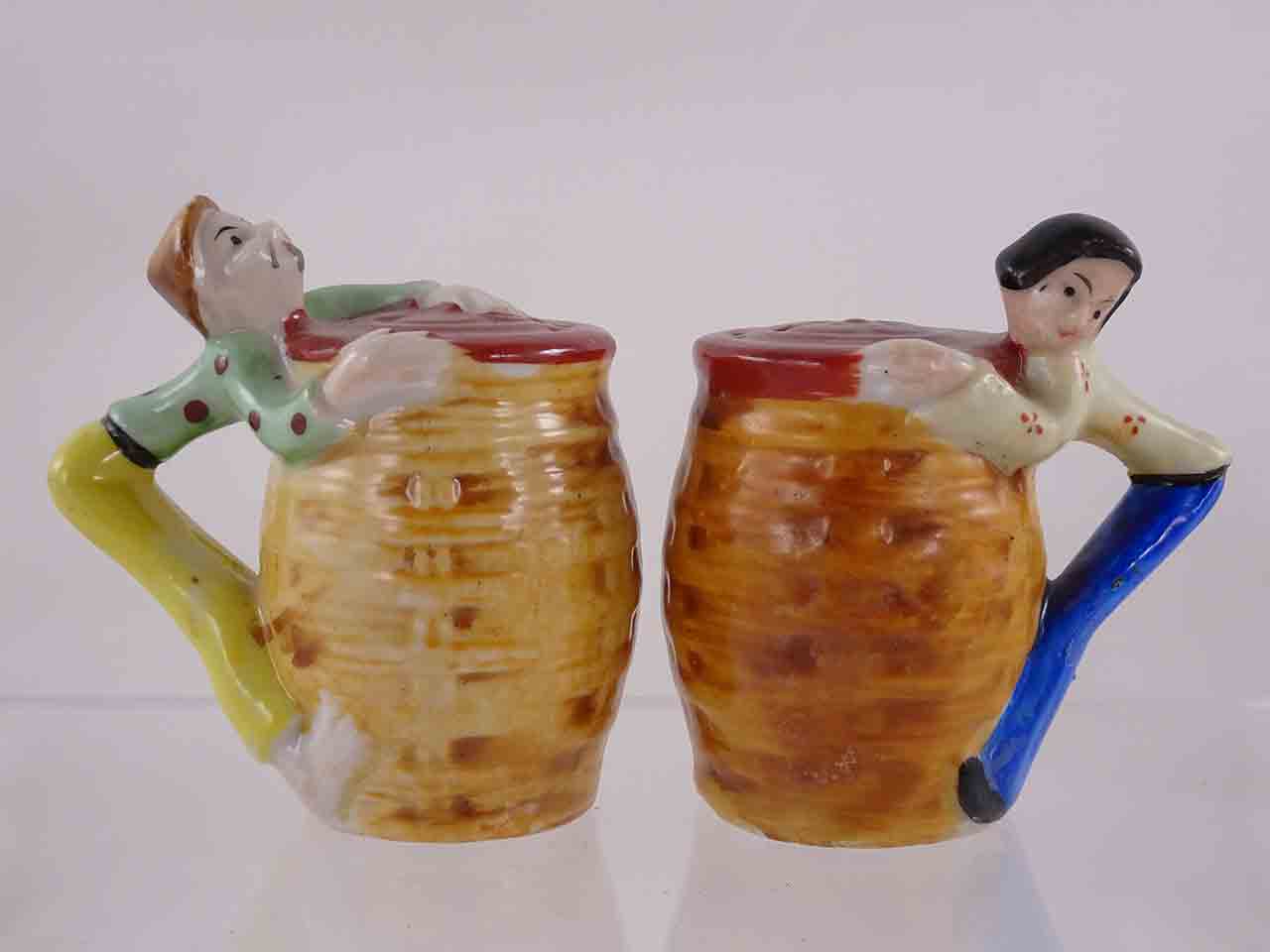 People hanging off sides of baskets salt and pepper shakers
